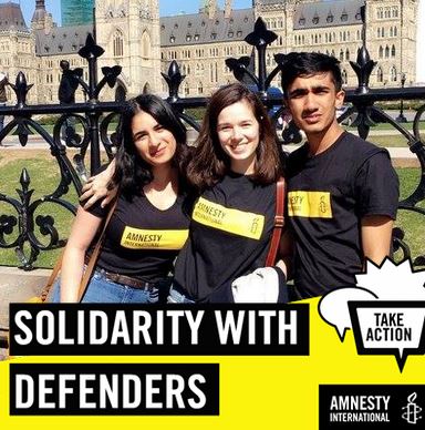 Two teenagers smiling at the camera. 'Solidarity with Defenders' is written beneath the photo.
